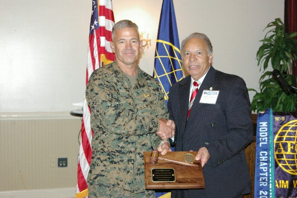 Col. Jim Turner, USMC, past chapter president, receives an award for his service to the chapter from Lou Ramos, regional vice president, in February.